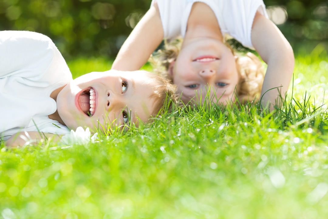 young children playing in grass