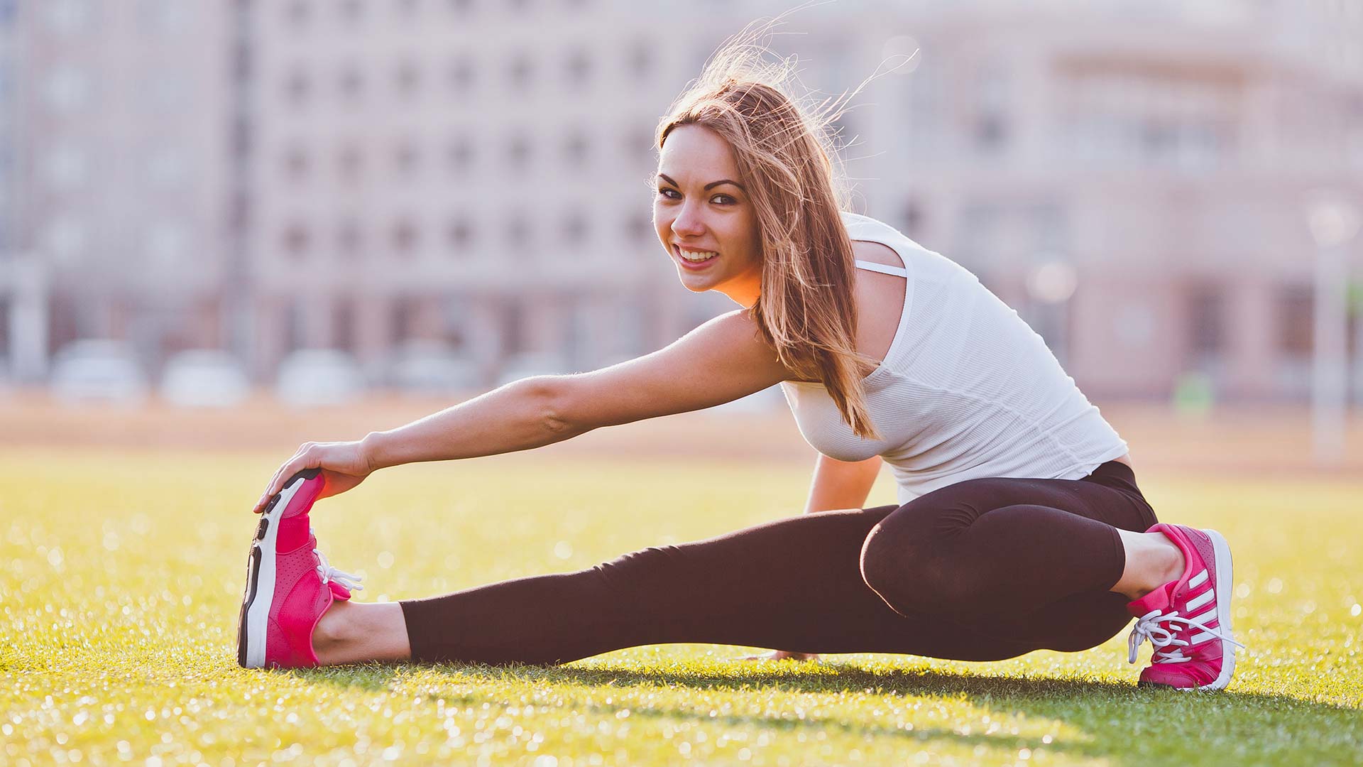 College aged woman stretching