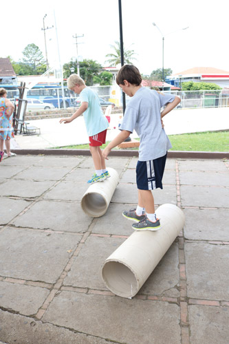 Kids rolling on cardboard cores