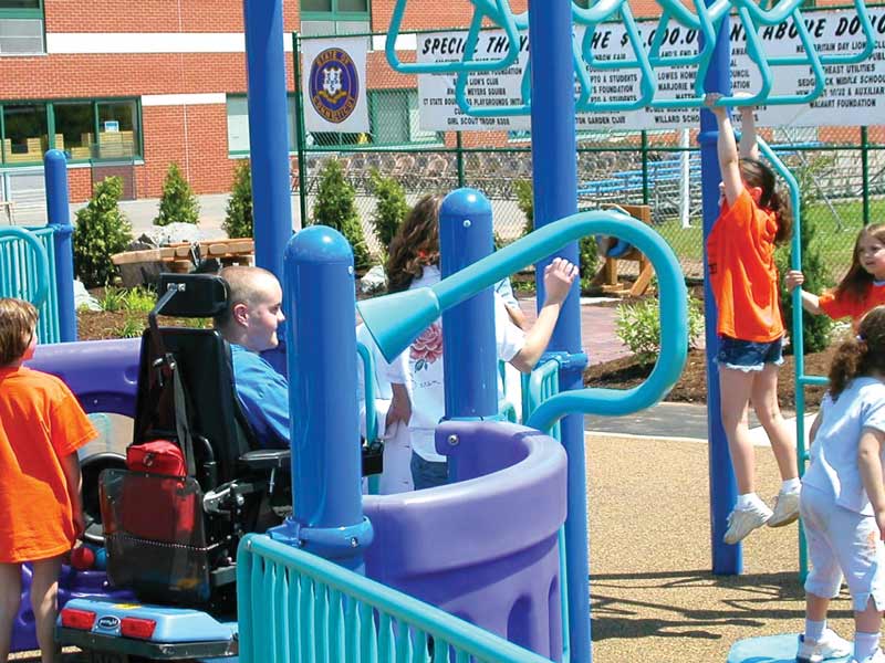 Kids on inclusive playground equipment