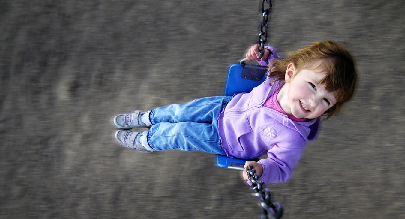 girl swinging on a swing set