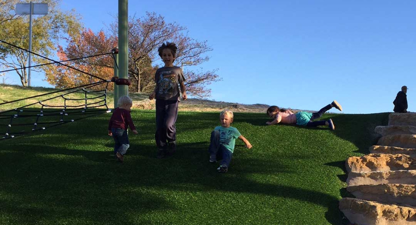 children playing on a sloped playground