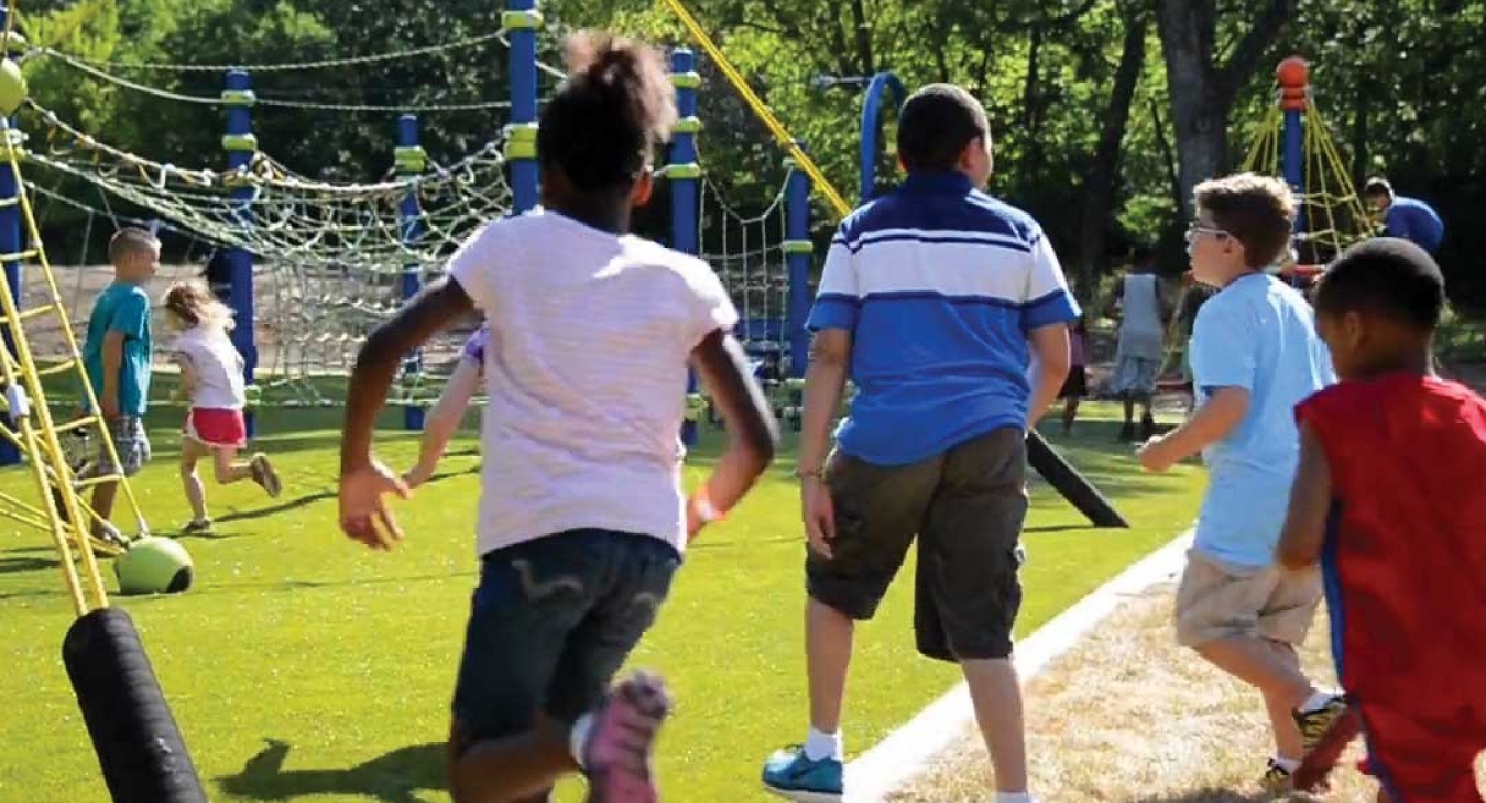 group of kids running to a newly completed playground