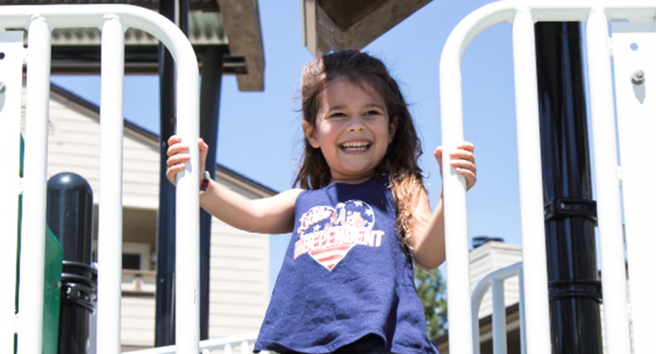 Girl on top of sanitized playground equipment