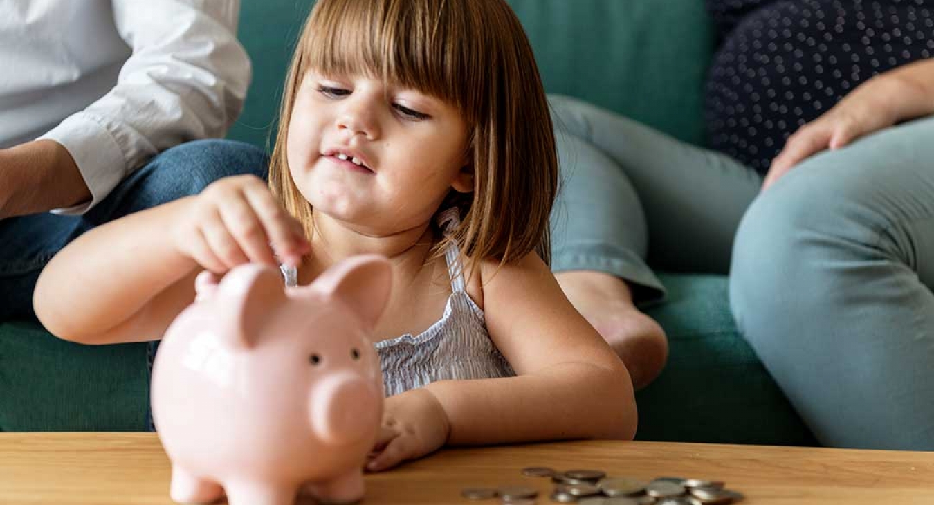 family saving money in a piggy bank