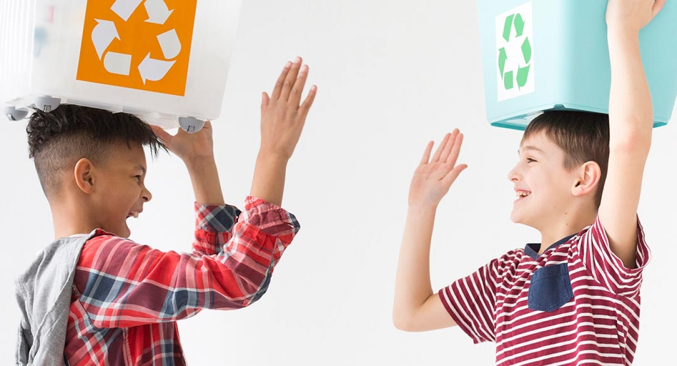 young boys happy to recycle together