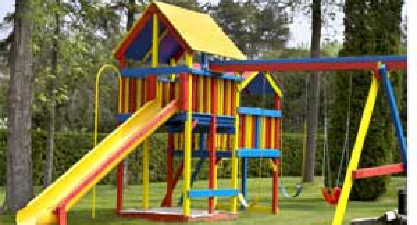 Grass as surfacing under playset