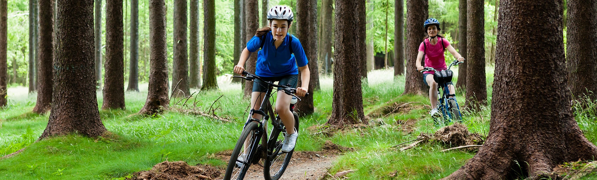 mother and daughter biking in the woods 
