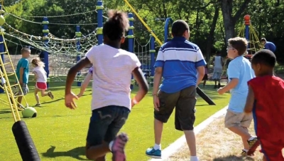 group of kids running to a newly completed playground